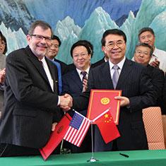Kaler shaking hands with Chinese official