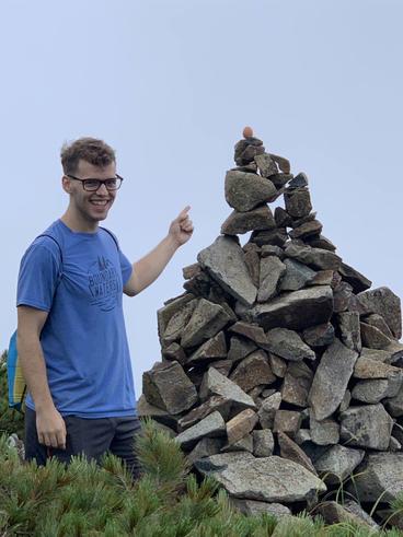 Adam Kleist poses with a rock pile