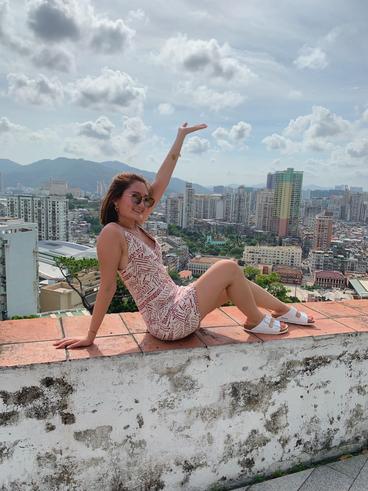Alexis Moy poses with the Hong Kong skyline