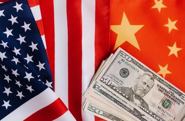 US and China flags with US dollars on top