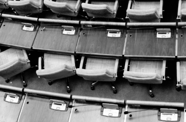 rows of chairs at long desks in an auditorium