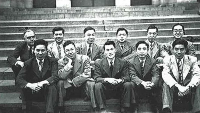 Ten Chinese students pose in suits on some steps