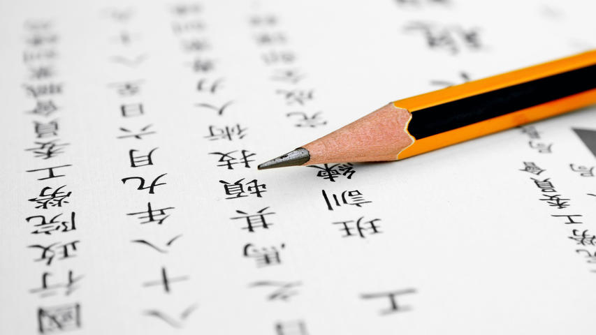 Pencil laying on page with Chinese writing